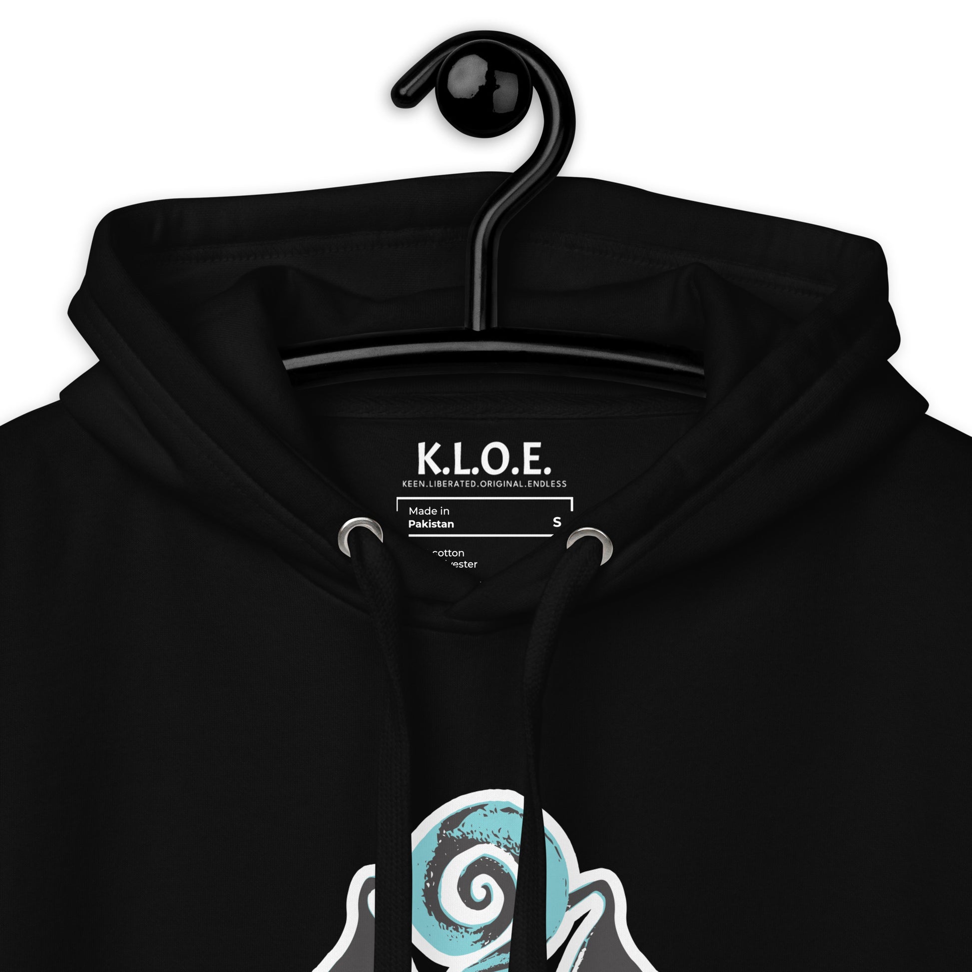 Inside label view of black K.L.O.E. hoodie featuring a hand-drawn design of two mirrored faces in teal and white, highlighting culturally inspired, bohemian style fashion with a focus on individuality, artistic expression, and modern eco-friendly fashion, worn by a model.