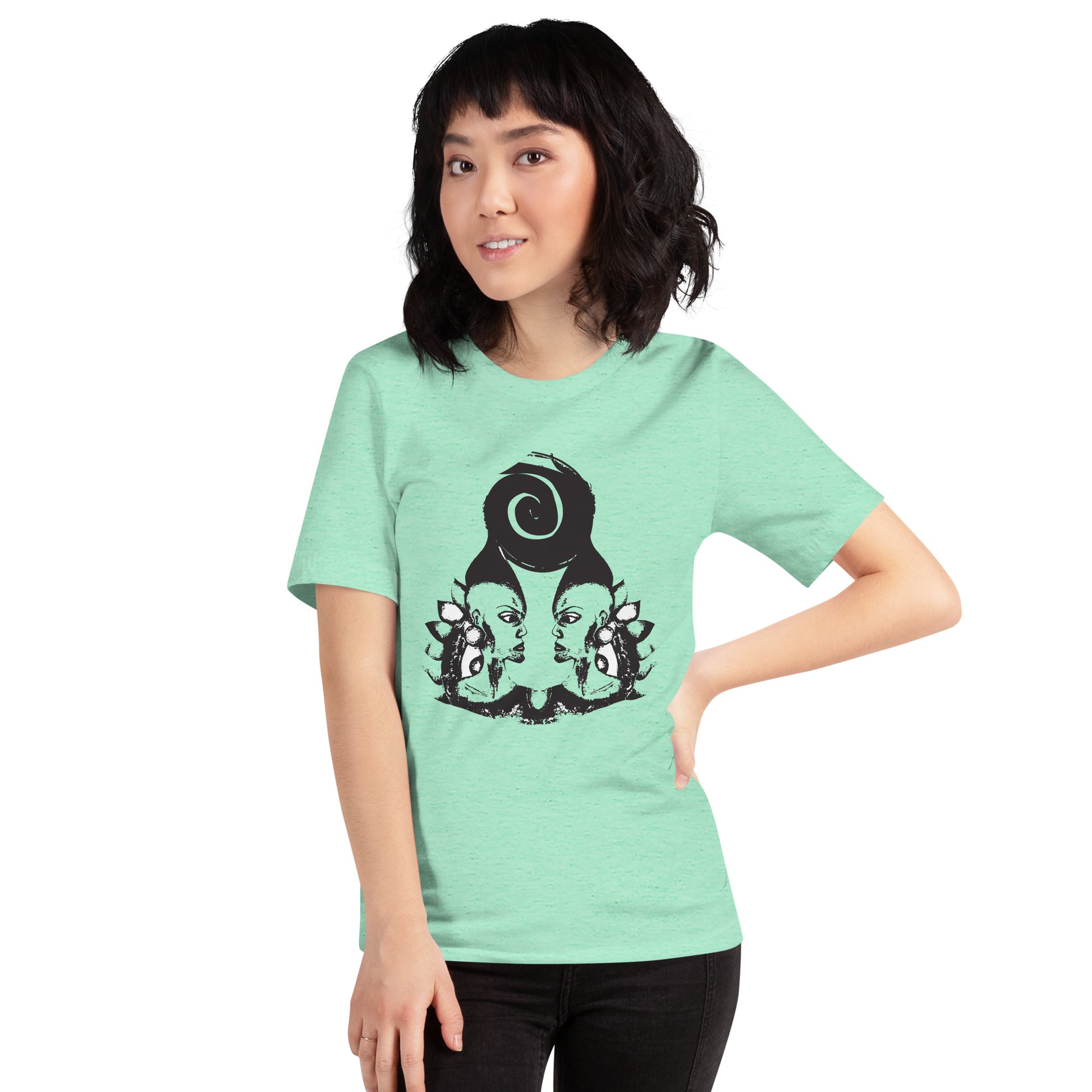 A model wearing mint t-shirt featuring wearable illustrations with an art-inspired black design of mirrored female faces and a bold central spiral symbol, celebrating expressive fashion and individuality – unique clothing by K.L.O.E.