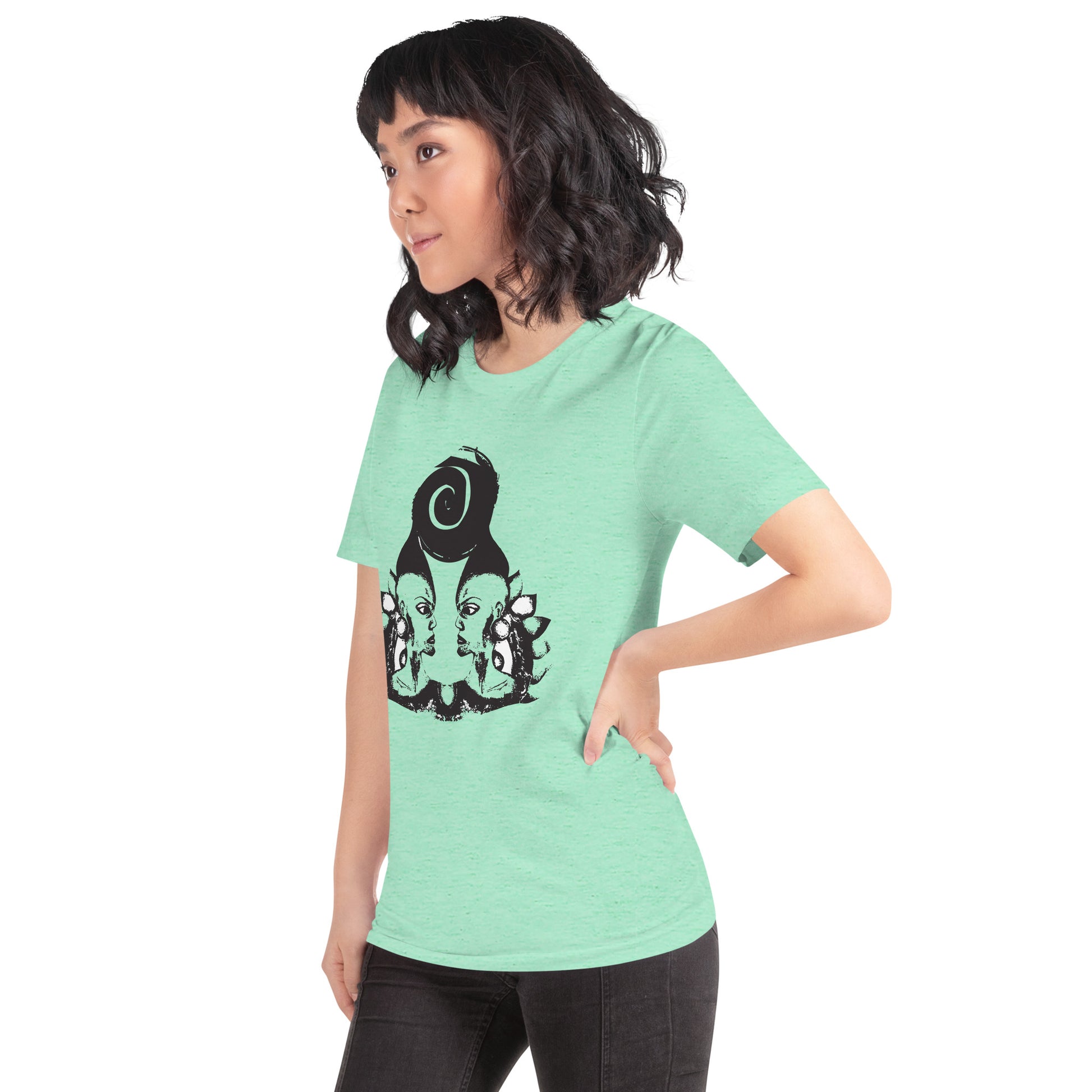A model wearing mint t-shirt featuring wearable illustrations with an art-inspired black design of mirrored female faces and a bold central spiral symbol, celebrating expressive fashion and individuality – unique clothing by K.L.O.E.