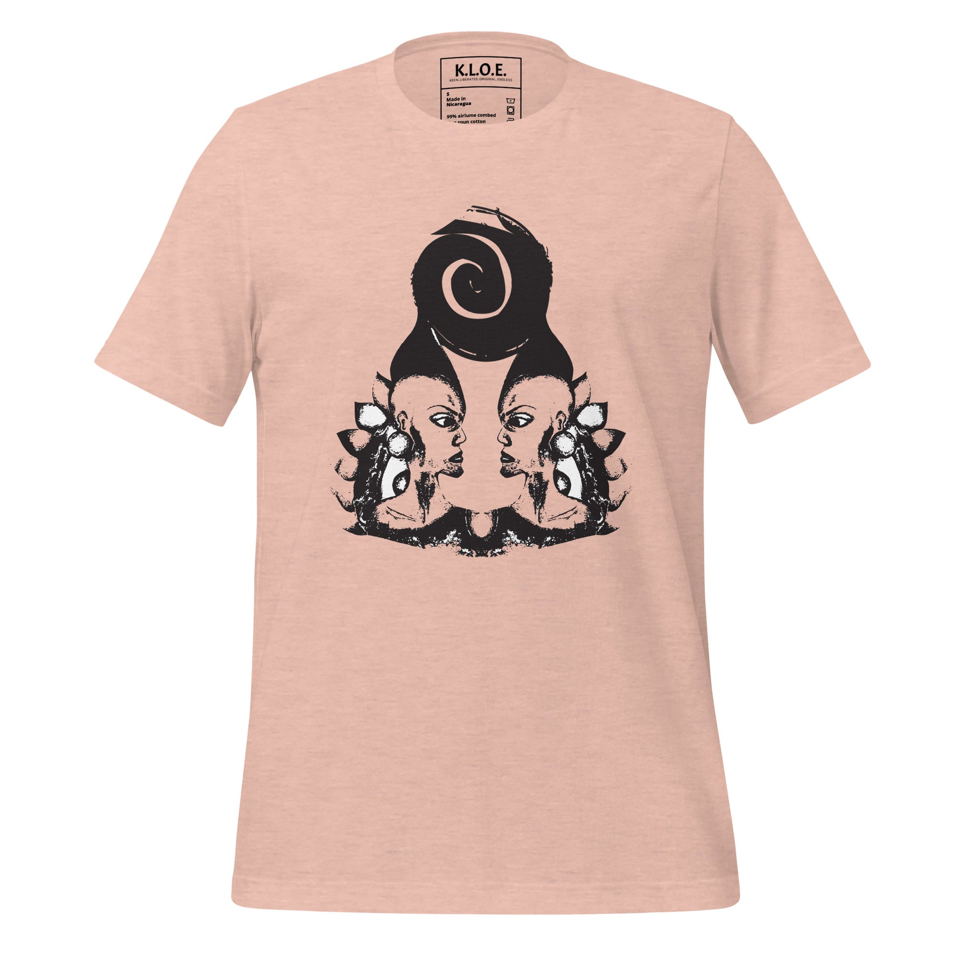 Peach color t-shirt featuring a hand-drawn black ink design of two mirrored female figures with bold, intricate headpieces, connected by a swirling central element. This artistic piece from K.L.O.E. embraces cultural inspiration and self-expression, crafted for those who appreciate unique, expressive fashion and modern bohemian style. 