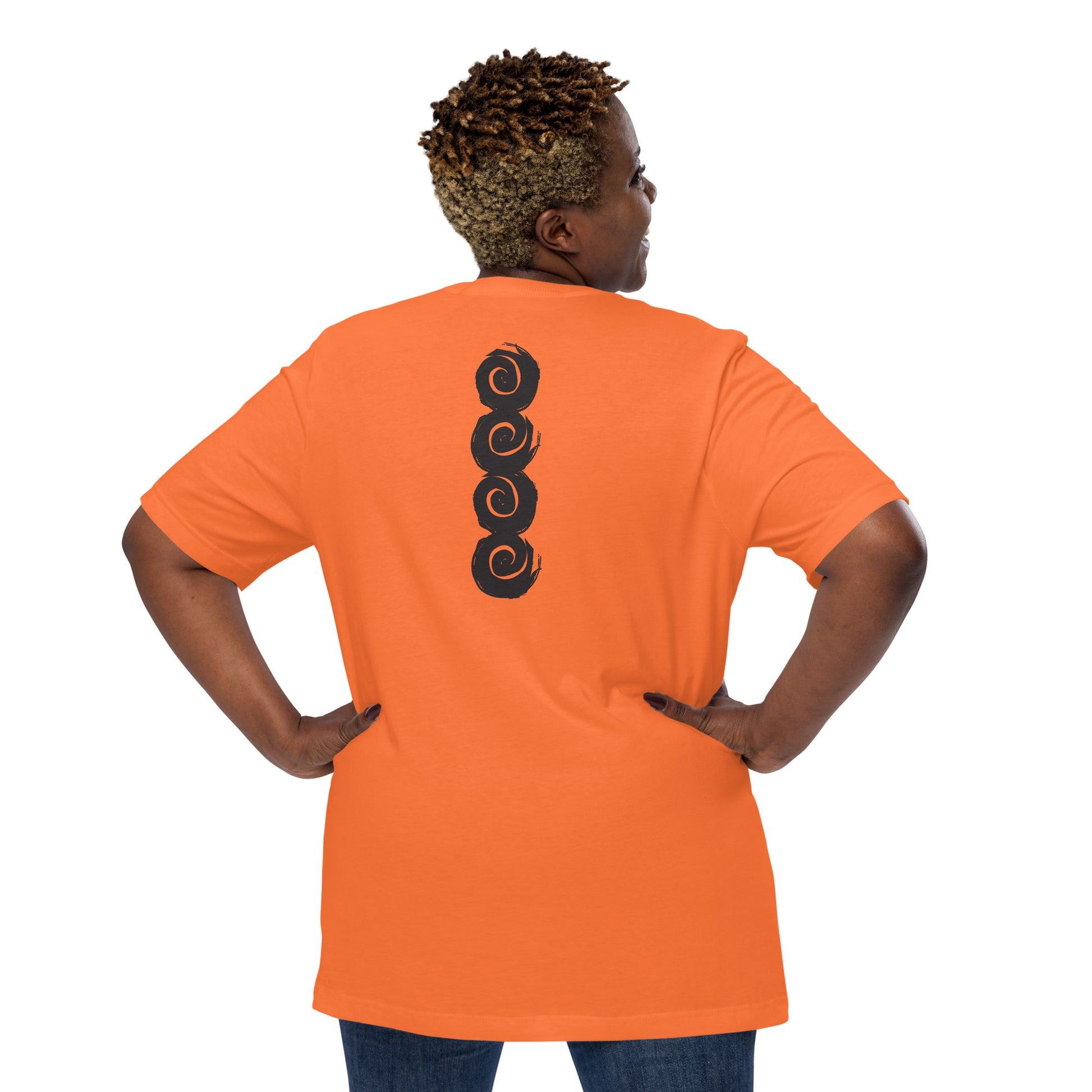 Back of an orange t-shirt featuring a vertical row of four bold, black spiral symbols, hand-drawn in an expressive, brushstroke style. This culturally inspired design from K.L.O.E. highlights artisan craftsmanship and modern boho style, perfect for those who seek unique, eco-friendly fashion and artistic self-expression, worn by a plus size model.