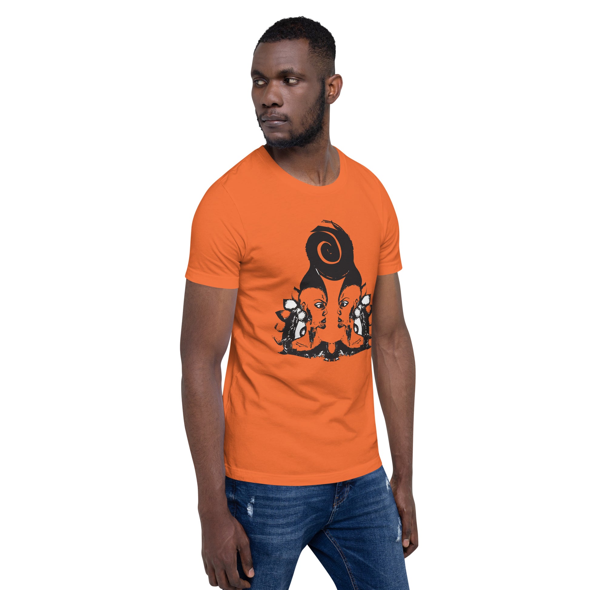 A male model wearing orange t-shirt featuring a hand-drawn black ink design of two mirrored female figures with bold, intricate headpieces, connected by a swirling central element. This artistic piece from K.L.O.E. embraces cultural inspiration and self-expression, crafted for those who appreciate unique, expressive fashion and modern bohemian style.