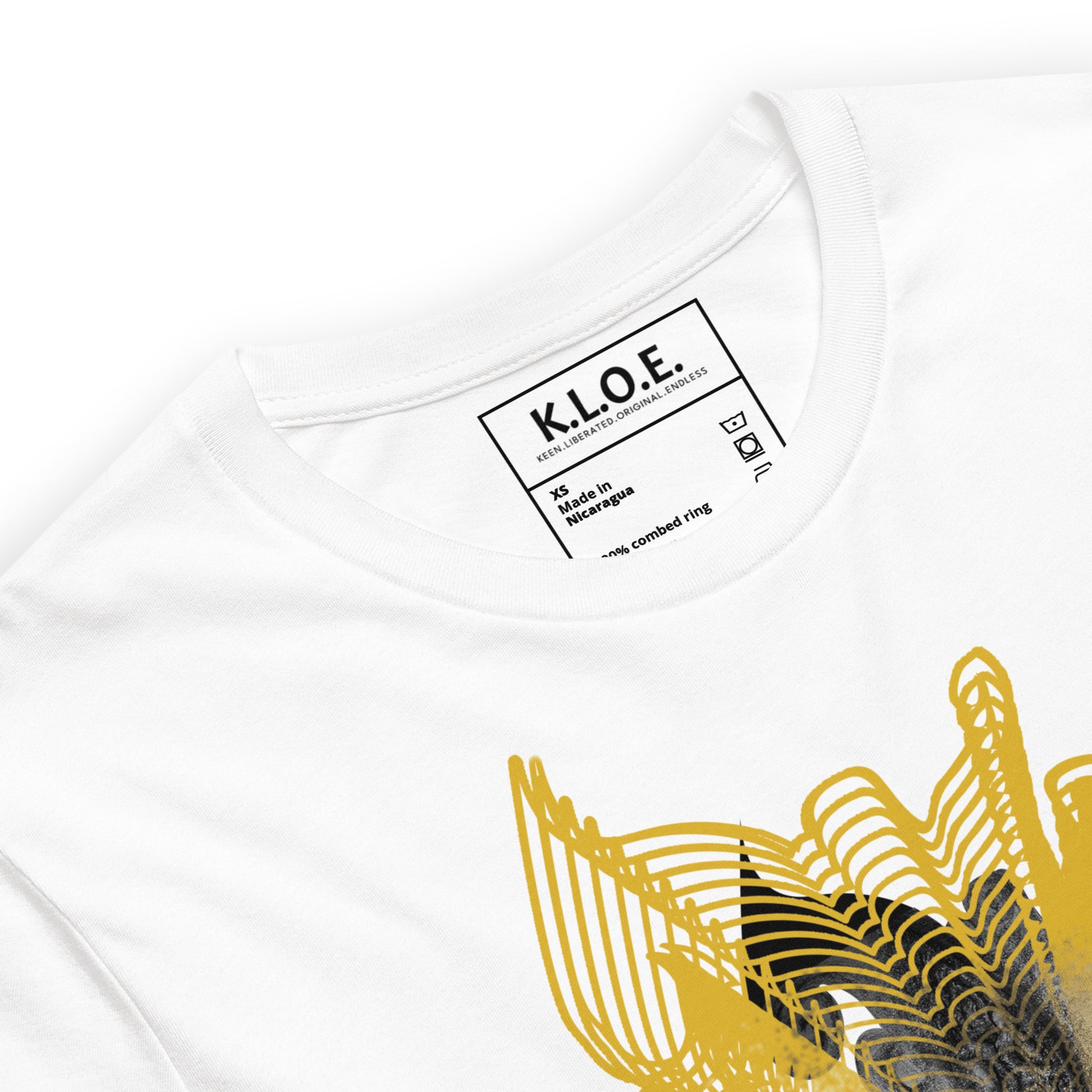 Detail view of a front of a white K.L.O.E. T-shirt featuring a striking hand-drawn face design surrounded by radiant golden abstract patterns—an artistic and empowering piece of handcrafted fashion, blending bohemian style clothing with contemporary fashion for bold self-expression and individuality.
