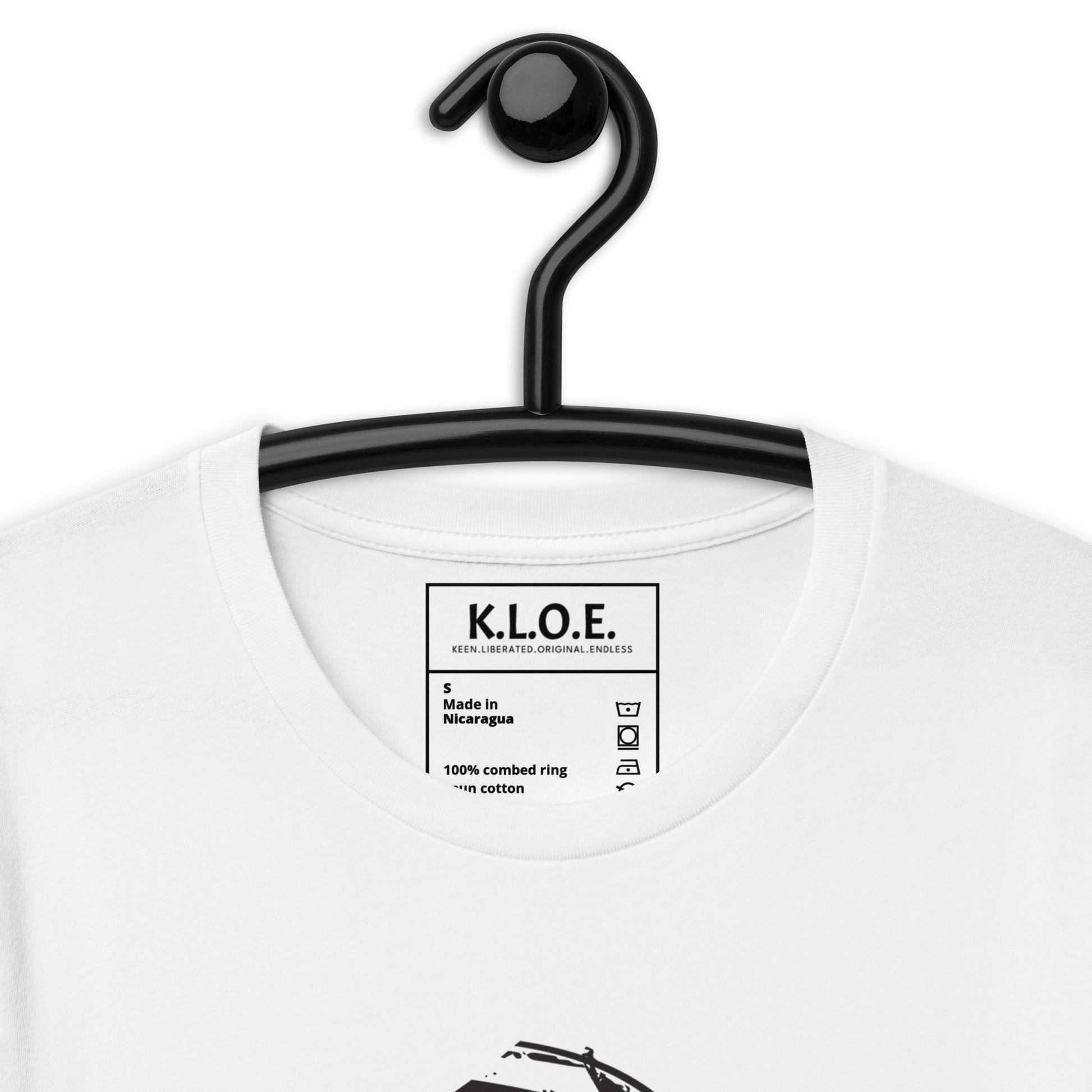 White t-shirt, on a hanger, featuring wearable illustrations with an art-inspired black design of mirrored female faces and a bold central spiral symbol, celebrating expressive fashion and individuality – unique clothing by K.L.O.E., detail view showing theinside label.