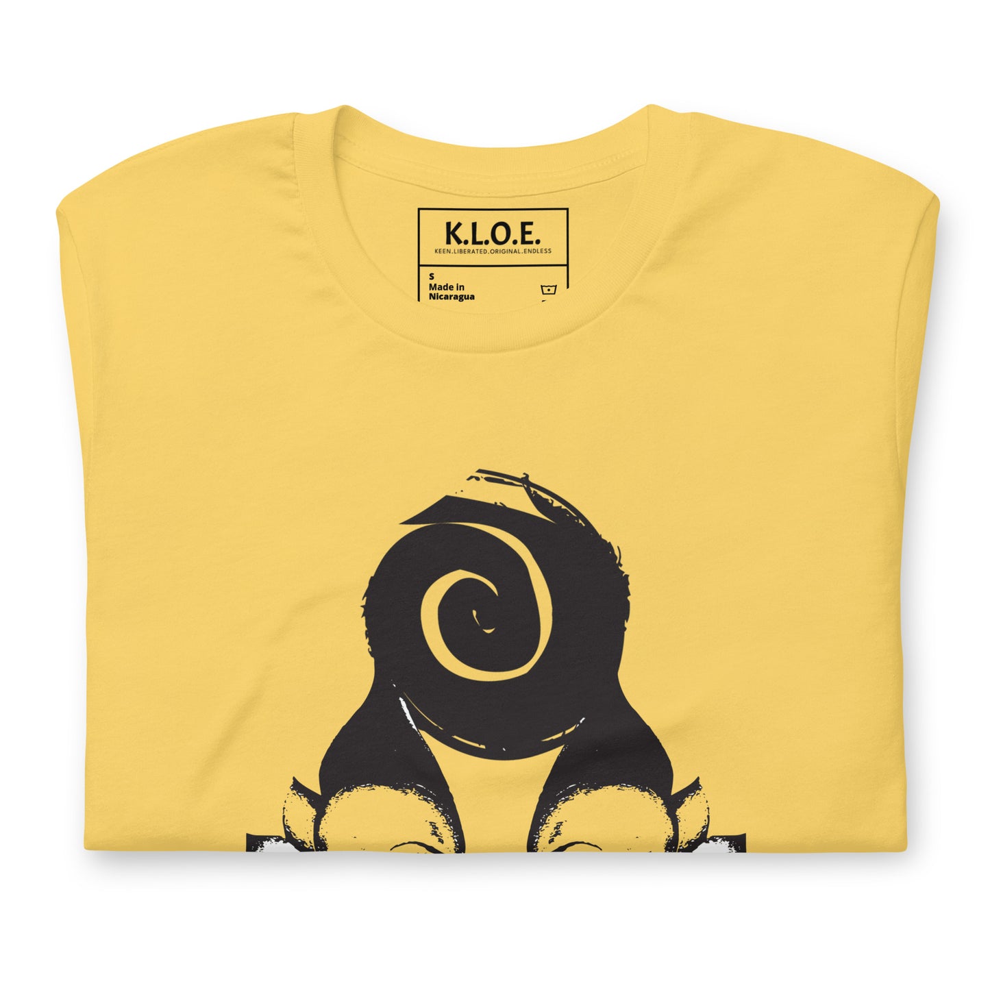 Yellow t-shirt featuring wearable illustrations with an art-inspired black design of mirrored female faces and a bold central spiral symbol, celebrating expressive fashion and individuality – unique clothing by K.L.O.E., detail view.