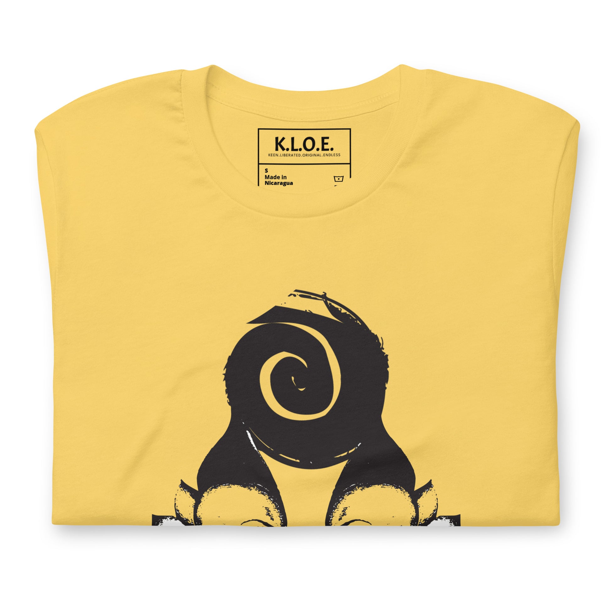 Yellow t-shirt featuring wearable illustrations with an art-inspired black design of mirrored female faces and a bold central spiral symbol, celebrating expressive fashion and individuality – unique clothing by K.L.O.E., detail view.