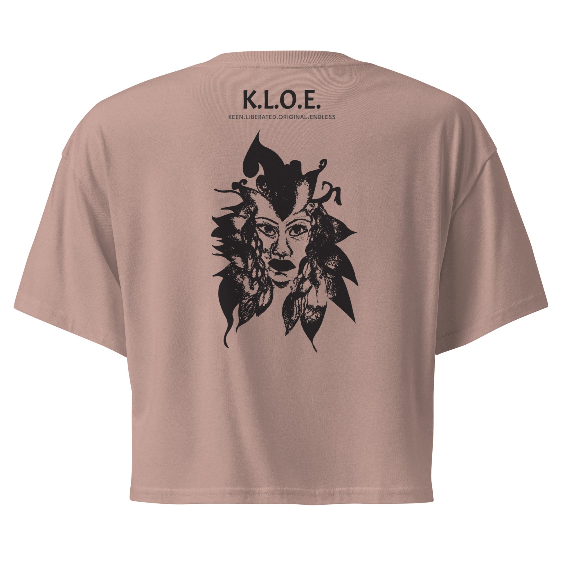 Back view of a hazy pink K.L.O.E. crop t-shirt showcasing a culturally inspired, hand-drawn black design featuring a bold, expressive face intertwined with flowing, abstract patterns, and K.L.O.E. logo, embodying artistic self-expression and modern bohemian style fashion.