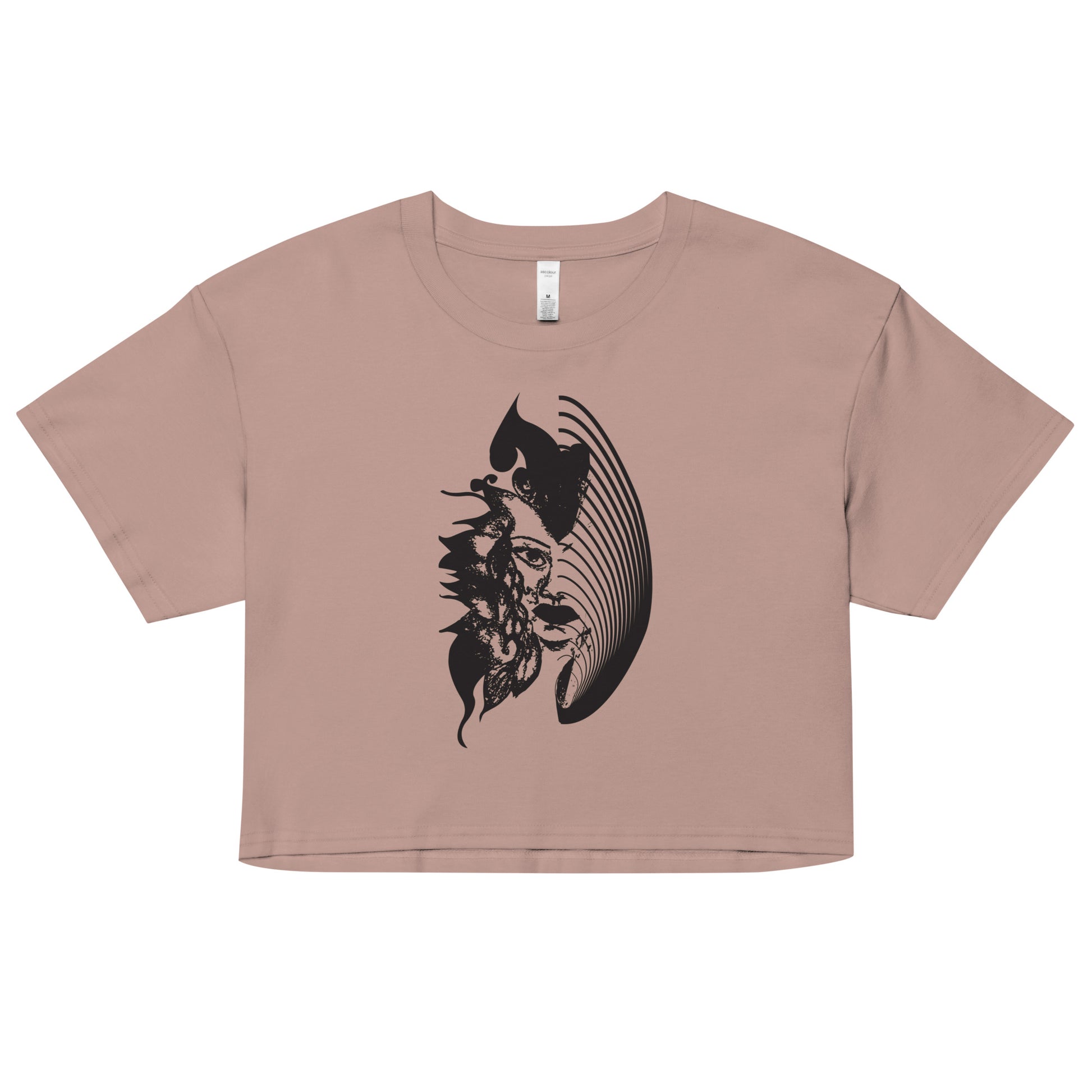 A hazy pink K.L.O.E. crop t-shirt featuring a culturally inspired, hand-drawn black graphic of a bold, expressive face surrounded by intricate details, celebrating individuality and artistic self-expression in modern bohemian style fashion.