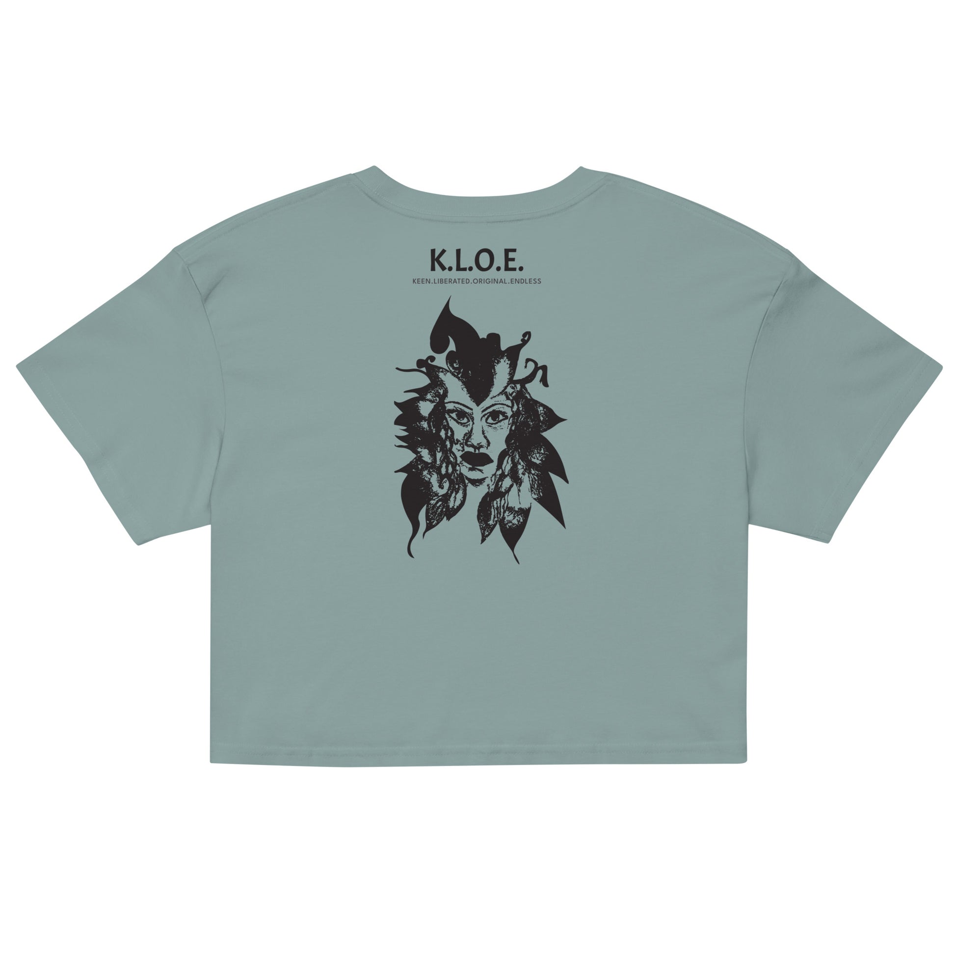 Back view of a mineral K.L.O.E. crop t-shirt showcasing a culturally inspired, hand-drawn black design featuring a bold, expressive face intertwined with flowing, abstract patterns, and K.L.O.E. logo, embodying artistic self-expression and modern bohemian style fashion.