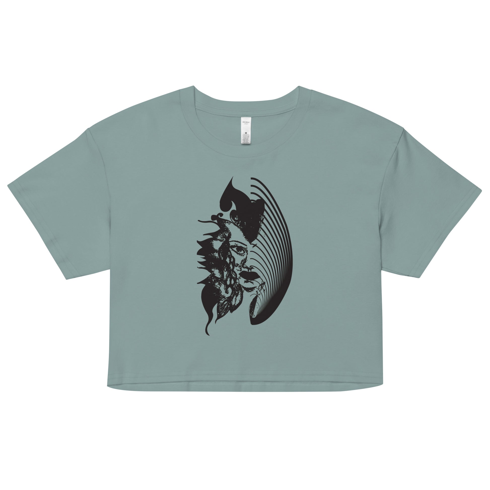 A mineral K.L.O.E. crop t-shirt featuring a culturally inspired, hand-drawn black graphic of a bold, expressive face surrounded by intricate details, celebrating individuality and artistic self-expression in modern bohemian style fashion.