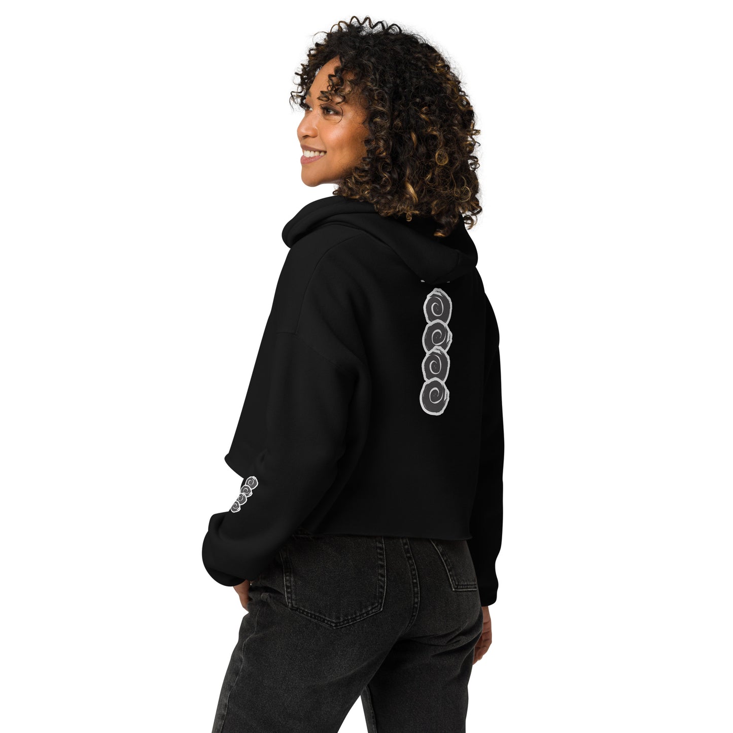 Back view of a black cropped hoodie featuring a vertical row of three hand-drawn white spirals in a bold, brushstroke style. This unique, culturally inspired design from K.L.O.E. embodies modern boho style and artistic expression, ideal for those seeking eco-friendly, artisan fashion with a contemporary edge.