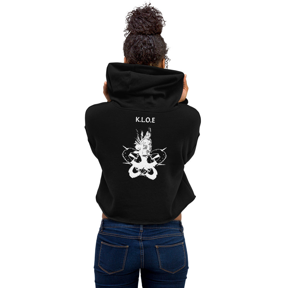 Back view of black unisex K.L.O.E. crop hoodie with white abstract hand-drawn illustration of two faces intertwined with organic shapes and cultural symbolism—expressing metamorphosis, identity, and artistic freedom.