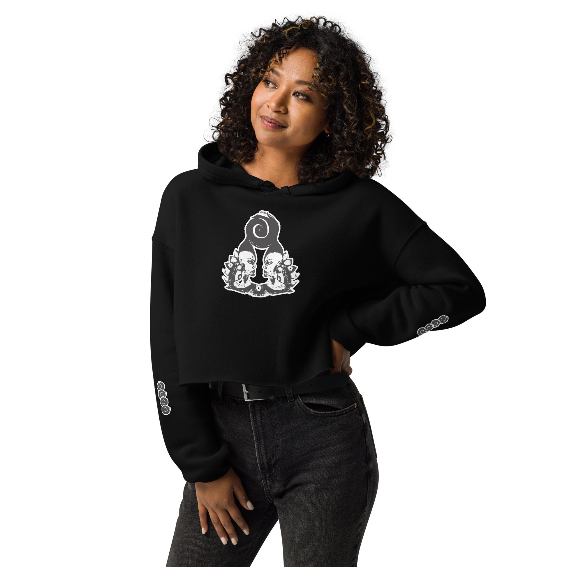 Black cropped hoodie featuring a white, hand-drawn graphic of two mirrored female figures with bold, intricate headpieces and a swirling central element. This culturally inspired, artisan design from K.L.O.E. captures modern boho style and expressive fashion, perfect for individuals seeking unique, eco-friendly apparel that celebrates self-expression and global artistry.
